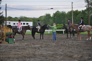 Horseback Riding Lessons - Terri Young teaching a group of young riders